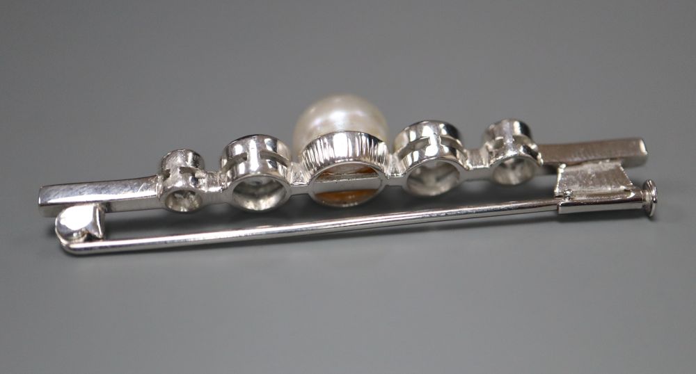 A white metal single stone cultured pearl and four stone diamond set bar brooch, 48mm, gross 4.9 grams.